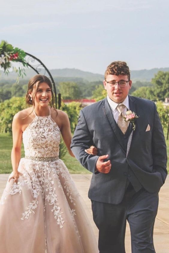 long formal prom dress features halter neckline and lace appliques cg21708