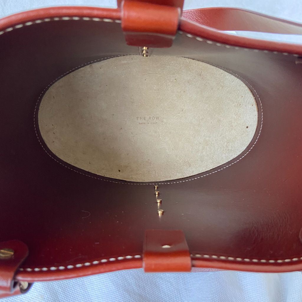 The Row beige canvas and leather bucket bag