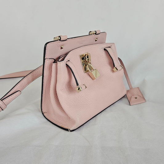 Valentino pink textured leather crossbody flap bag with lock