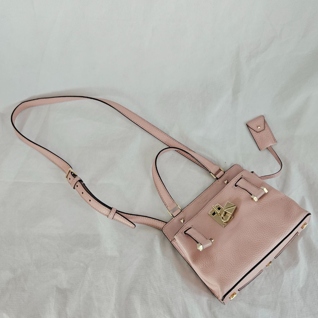 Valentino pink textured leather crossbody flap bag with lock