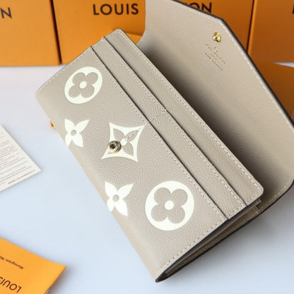 LOUIS VUITTON SARAH WALLET BICOLOR MONOGRAM EMPREINTE TOURTERELLE AND CRÈME 19CM M81049