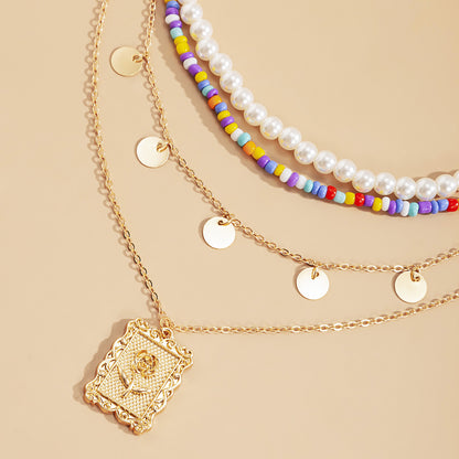 Multiple sets of pearl metal necklaces