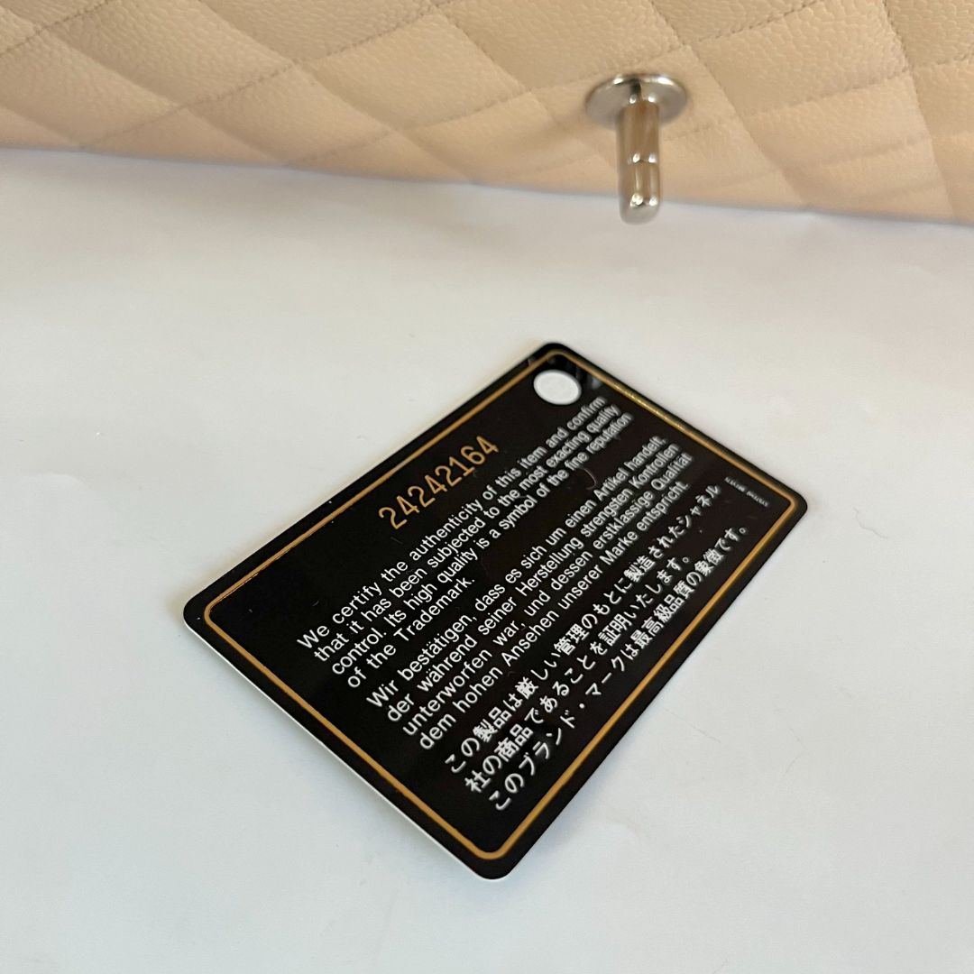 Chanel beige caviar quilted leather maxi double flap bag