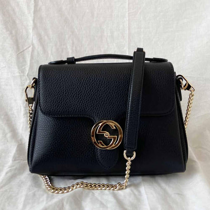 Gucci interlocking G black leather flap bag with goldtone hardware