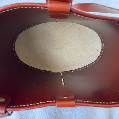 The Row beige canvas and leather bucket bag