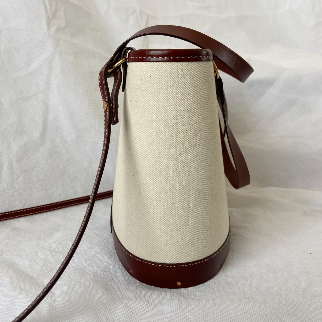 The Row beige canvas and leather bucket bag