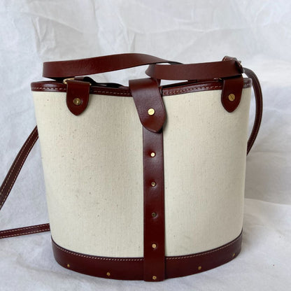 The Row beige canvas and leather bucket bag