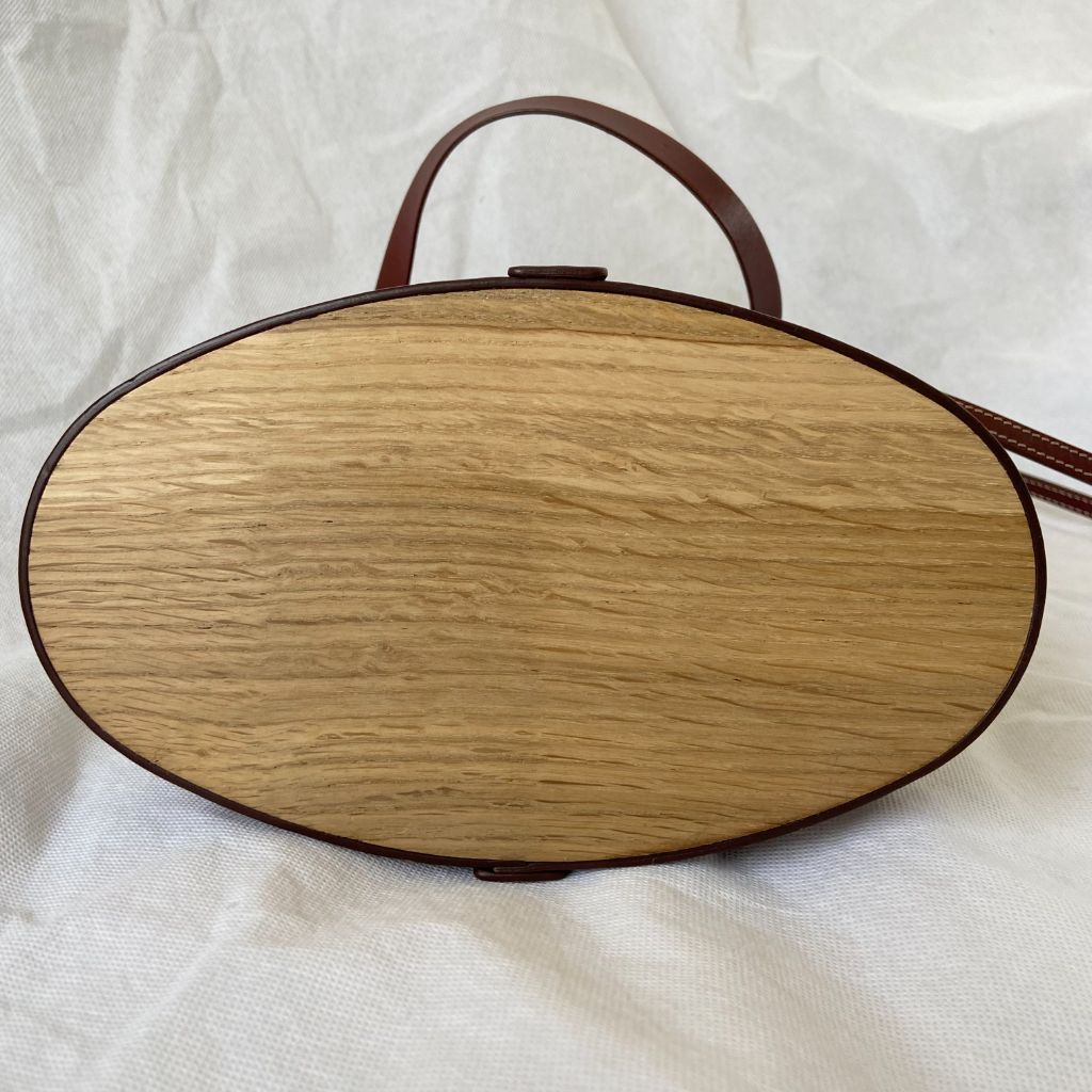 The Row beige canvas and leather bucket bag